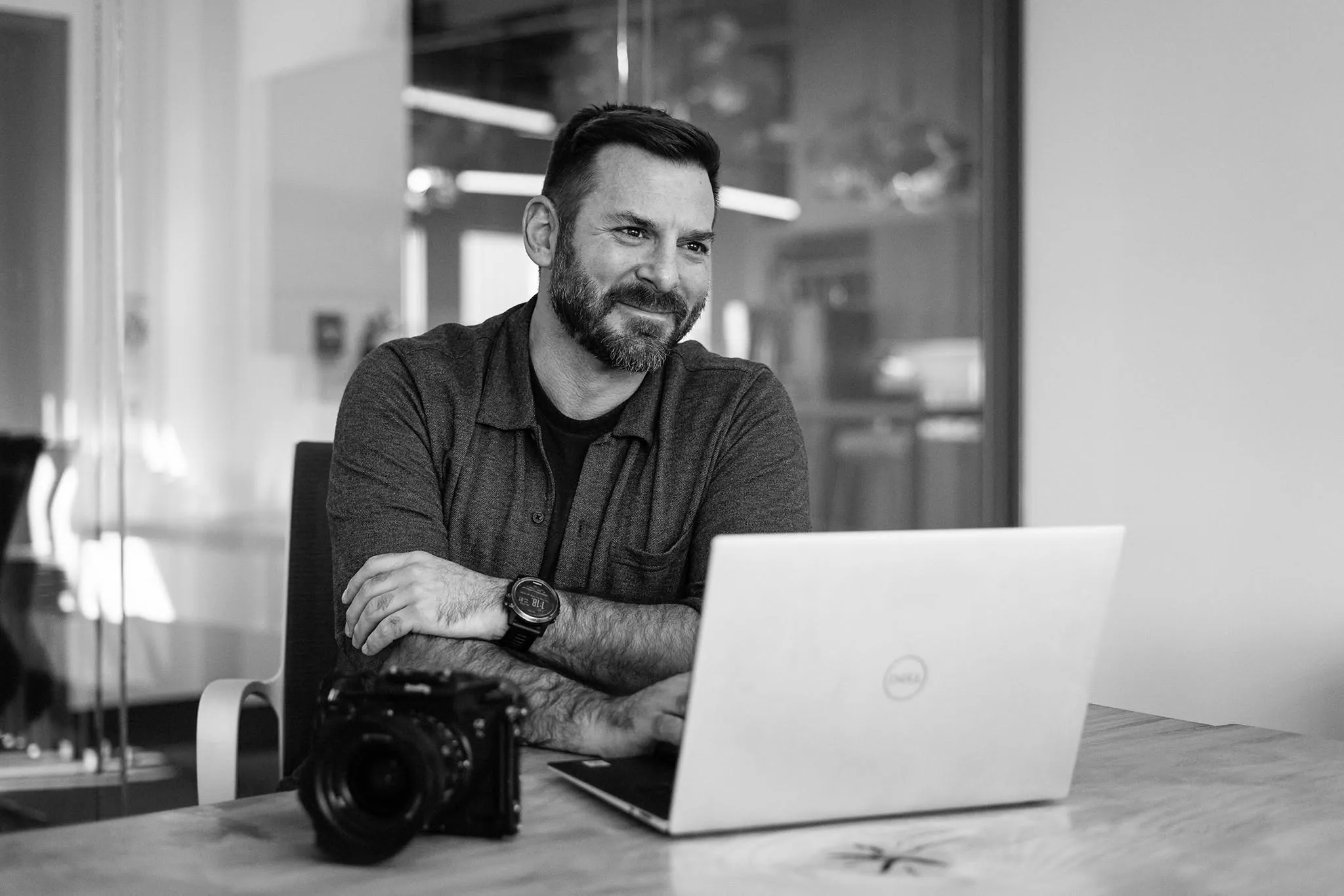 Michael Bonocore at his desk with a camera and a laptop